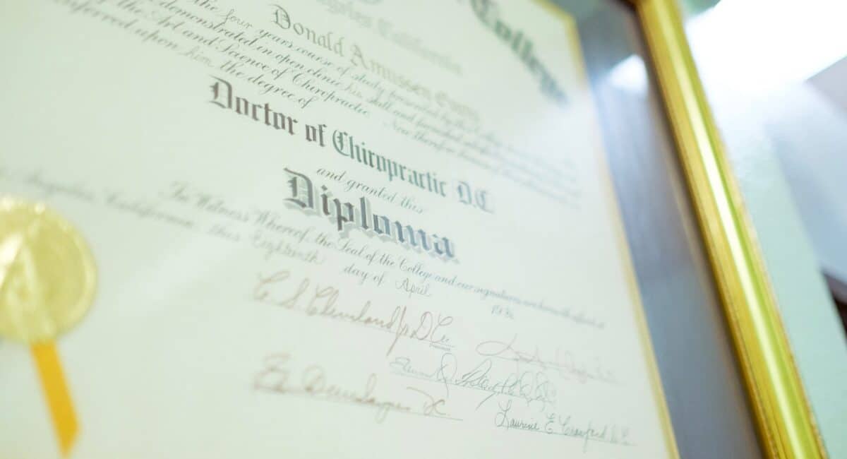 a framed diploma with a gold seal on it