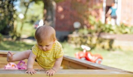 baby trying to get out of his crib